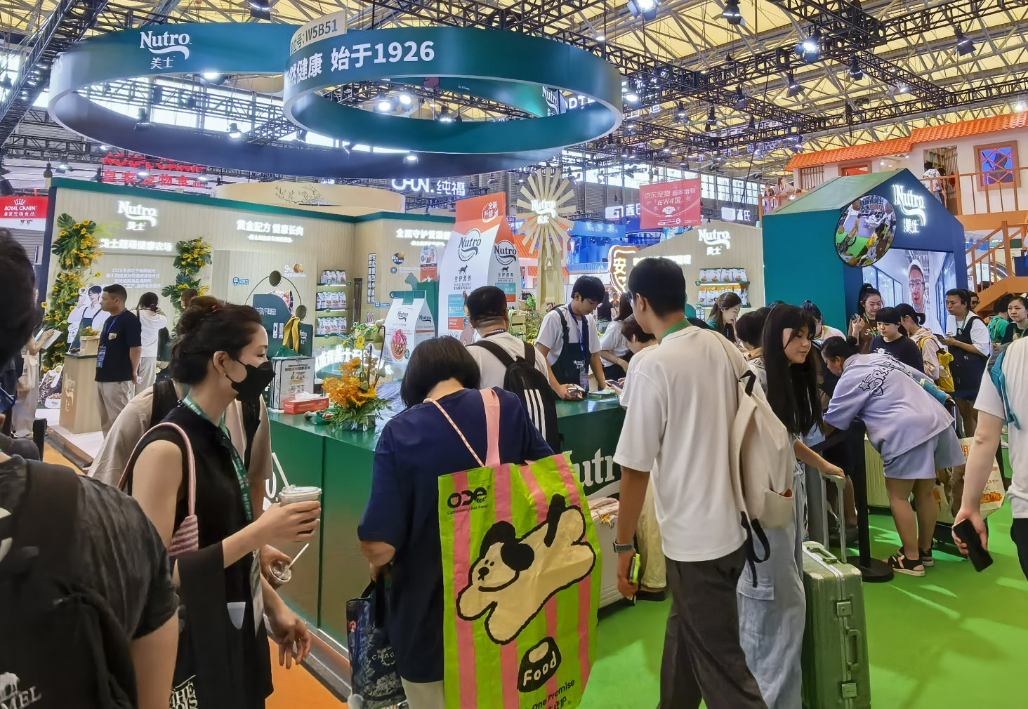 Visitors at a branded pet-products exhibition booth at the 2025 Asia Pet Fair