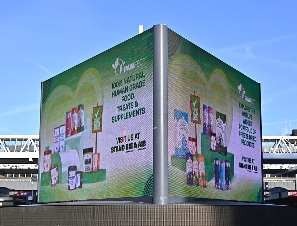 Figure 4. Outdoor advertising around the NEC during PATS 2025 — Pawfect's digital billboard promoting its stands B15 & A18. Field photo from the author's on-site collection, PATS 2025.