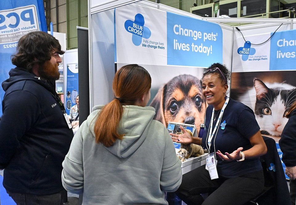 Figure 25. The Blue Cross booth at PATS 2025 — a charity presence with plush merchandise and leaflets on the counter. Field photo from the author's on-site collection, PATS 2025.